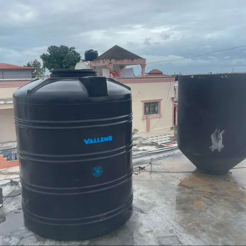 Rooftop water storage tank connected to supply piping
